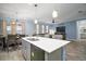 View from modern kitchen showcasing stainless steel appliances, an island with seating, and an open layout to the living room at 1155 Dora Parc Ln, Mount Dora, FL 32757