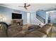 Bright living room with hardwood floors and cozy sectional sofa facing a large television at 1155 Dora Parc Ln, Mount Dora, FL 32757