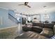 Open-concept living room features hardwood floors, modern furnishings and flows into the kitchen and dining area at 1155 Dora Parc Ln, Mount Dora, FL 32757