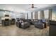 Open-concept living room and kitchen with hardwood-style floors and a large sectional sofa at 1155 Dora Parc Ln, Mount Dora, FL 32757