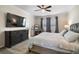 Spacious main bedroom featuring a plush bed, dark wood dresser, vanity, and a flat screen television at 1155 Dora Parc Ln, Mount Dora, FL 32757