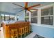 Enclosed patio with hot tub, bar, ceiling fan, and screened windows at 1155 Dora Parc Ln, Mount Dora, FL 32757
