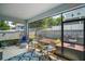 Enclosed patio with woven chair, seating, ceiling fan and screened windows at 1155 Dora Parc Ln, Mount Dora, FL 32757