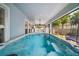 Enclosed in-ground pool with ceiling fan, screened windows and outdoor seating at 1155 Dora Parc Ln, Mount Dora, FL 32757