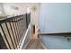 Carpeted stairs descend to the lower level, with railing and view to living area at 1155 Dora Parc Ln, Mount Dora, FL 32757