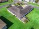 Aerial view of the home with lush backyard, screened lanai, and mature landscaping at 12118 Se 175Th Loop, Summerfield, FL 34491