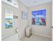Neutral bathroom features tile flooring and dual stained-glass windows at 12118 Se 175Th Loop, Summerfield, FL 34491