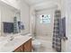 Well-lit bathroom boasts tiled shower and floors, along with a vanity at 12118 Se 175Th Loop, Summerfield, FL 34491