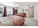 Comfortable bedroom featuring a cozy bed, ceiling fan, and dresser for organized storage at 12118 Se 175Th Loop, Summerfield, FL 34491
