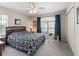 Comfortable bedroom with ceiling fan, carpet floors, and view to the outside at 12118 Se 175Th Loop, Summerfield, FL 34491