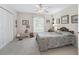 Spacious bedroom with a ceiling fan, closet, and a well-lit window at 12118 Se 175Th Loop, Summerfield, FL 34491