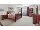Cozy bedroom with ample natural light, ceiling fan, and tasteful decor for relaxation at 12118 Se 175Th Loop, Summerfield, FL 34491