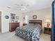 Bright bedroom features ceiling fan, carpet floors, and dresser at 12118 Se 175Th Loop, Summerfield, FL 34491