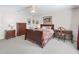Cozy bedroom featuring a ceiling fan, carpet floors, and traditional decor at 12118 Se 175Th Loop, Summerfield, FL 34491