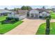 Beautiful home showcasing a large driveway, attached garage, and well-manicured lawn at 12118 Se 175Th Loop, Summerfield, FL 34491