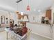 Open-concept kitchen with bar seating and stylish pendant lighting, perfect for entertaining at 12118 Se 175Th Loop, Summerfield, FL 34491