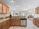 Kitchen with granite countertops, stainless steel appliances, and a view into the adjacent living space at 12118 Se 175Th Loop, Summerfield, FL 34491