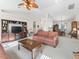 Open living area with vaulted ceilings, a large entertainment center, and comfortable seating at 12118 Se 175Th Loop, Summerfield, FL 34491