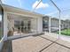 Covered patio featuring neutral tile and sunroom access at 12118 Se 175Th Loop, Summerfield, FL 34491