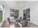 Charming sunroom features neutral tile, a ceiling fan, and a table set for four at 12118 Se 175Th Loop, Summerfield, FL 34491