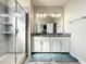 Elegant bathroom with a glass-enclosed shower and double vanity at 1342 Royal Saint George Blvd, Davenport, FL 33896