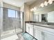 Elegant bathroom with a glass-enclosed shower and double vanity at 1342 Royal Saint George Blvd, Davenport, FL 33896