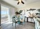 Bright dining area with a glass table, coastal accents, and outdoor patio access at 1342 Royal Saint George Blvd, Davenport, FL 33896