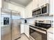 Well-equipped kitchen with stainless steel appliances and white cabinetry at 1342 Royal Saint George Blvd, Davenport, FL 33896
