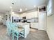 Modern kitchen with stainless steel appliances, an island with seating, and white cabinetry at 1342 Royal Saint George Blvd, Davenport, FL 33896
