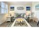 Serene living room with coastal decor, natural light, and stylish furnishings at 1342 Royal Saint George Blvd, Davenport, FL 33896