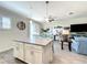 Bright, open-concept living area boasts a modern kitchen island and coastal-inspired decor at 1342 Royal Saint George Blvd, Davenport, FL 33896