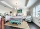 Serene main bedroom featuring a tray ceiling, stylish furnishings and ample natural light at 1342 Royal Saint George Blvd, Davenport, FL 33896