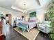 Serene main bedroom featuring a tray ceiling, stylish furnishings and ample natural light at 1342 Royal Saint George Blvd, Davenport, FL 33896