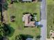 Overhead view of property with expansive lawn, screened lanai, mature trees, and desirable neighborhood setting at 13875 Se 97Th Ave, Summerfield, FL 34491