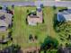 An aerial view of the home showcasing the lush green lawn and landscaped backyard at 13875 Se 97Th Ave, Summerfield, FL 34491