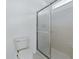 Shower with glass doors, tiled walls, and toilet at 13875 Se 97Th Ave, Summerfield, FL 34491