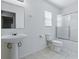 Bright bathroom with a pedestal sink, tiled floor, toilet, and shower-tub combination at 13875 Se 97Th Ave, Summerfield, FL 34491