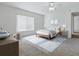 Nicely staged bedroom featuring a large window, stylish furniture, and soft colors at 13875 Se 97Th Ave, Summerfield, FL 34491
