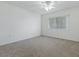 Bedroom with neutral carpet, a bright window, and a clean, minimalist design at 13875 Se 97Th Ave, Summerfield, FL 34491
