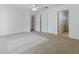 Large bedroom with neutral carpet and easy access to the walk-in closet and bathroom at 13875 Se 97Th Ave, Summerfield, FL 34491