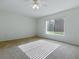Sunny bedroom featuring a large window, neutral carpet, and a ceiling fan at 13875 Se 97Th Ave, Summerfield, FL 34491