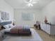Nicely staged bedroom showcasing modern decor, a cozy chair, and a soft color palette at 13875 Se 97Th Ave, Summerfield, FL 34491