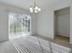 Bright dining room featuring a chandelier and sliding glass doors to the outdoor patio space at 13875 Se 97Th Ave, Summerfield, FL 34491