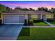 Charming single-story home featuring a well-manicured lawn and an attached two-car garage at 13875 Se 97Th Ave, Summerfield, FL 34491