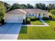 Well-maintained single-story home with a two-car garage, lush lawn, and inviting curb appeal at 13875 Se 97Th Ave, Summerfield, FL 34491