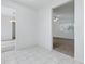 Hallway with bright tile flooring that seamlessly connects the living room, dining area and other spaces at 13875 Se 97Th Ave, Summerfield, FL 34491