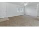Bright living room with neutral carpet, ceiling fan, and a large window at 13875 Se 97Th Ave, Summerfield, FL 34491