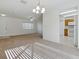 Open-concept living area with neutral tones, tile entryway and seamless access to the kitchen at 13875 Se 97Th Ave, Summerfield, FL 34491