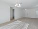 Spacious living area with neutral tones and seamless access to other rooms in the house at 13875 Se 97Th Ave, Summerfield, FL 34491