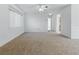 Spacious living room with carpet, a ceiling fan, and access to the kitchen and dining area at 13875 Se 97Th Ave, Summerfield, FL 34491
